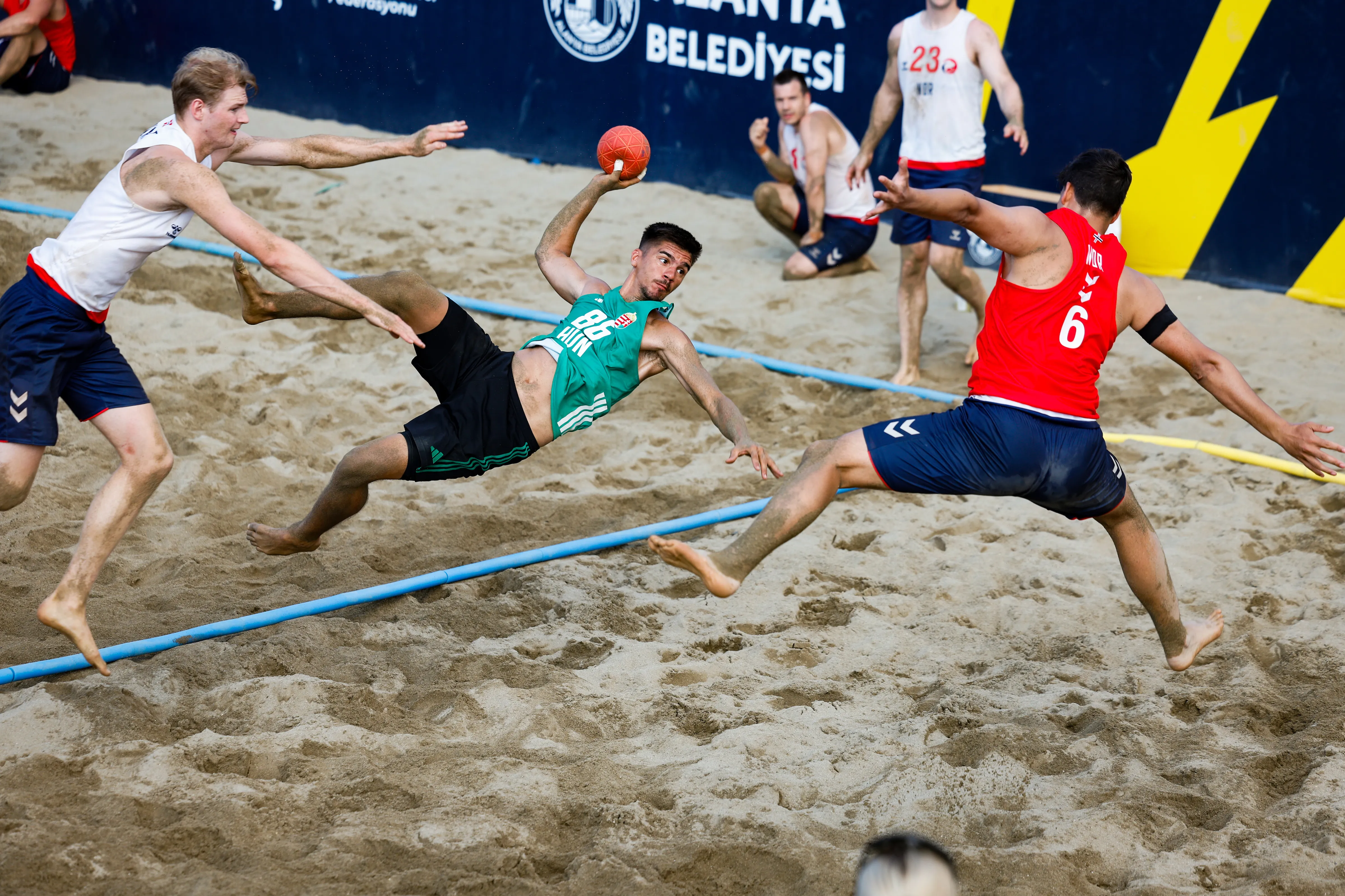Favourites through to main round as beach handball battle continues